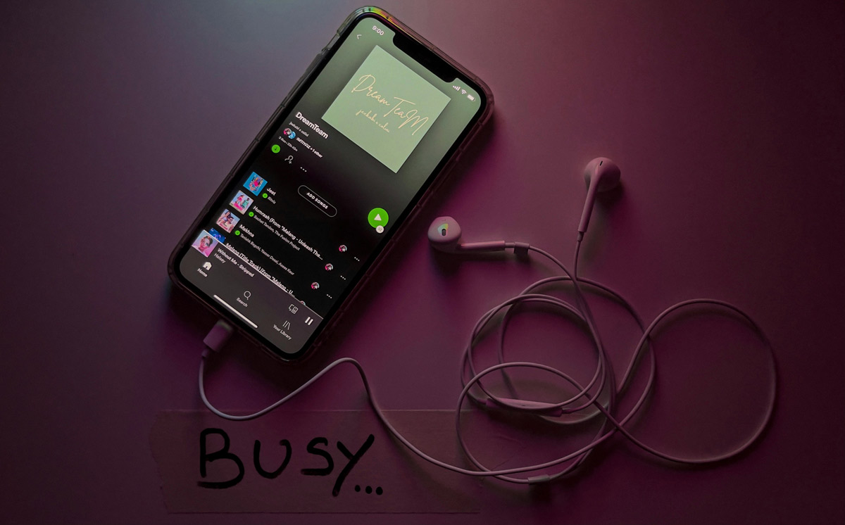 Mobile phone displaying Spotify playing a song, symbolising affordable music marketing, indie artist promotion, and cost-effective Spotify ad campaigns. Ideal visual for budget-friendly music promotion and Spotify ad campaign tips.